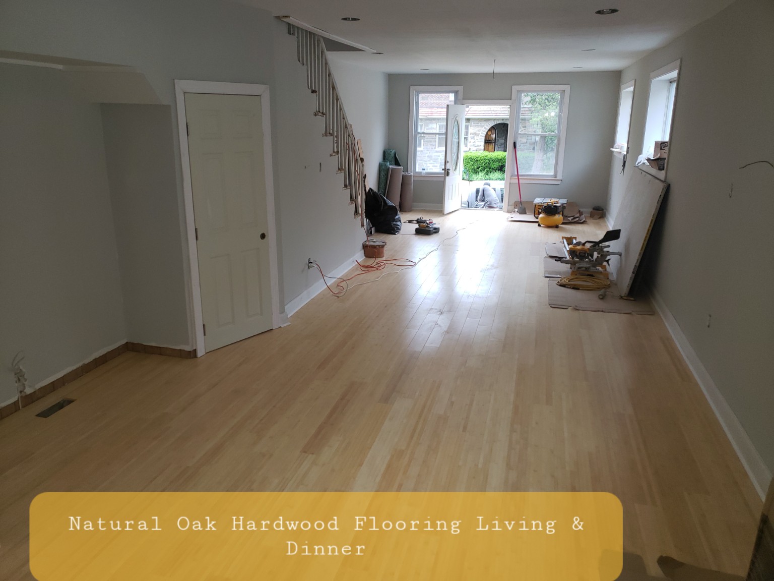 Natural oak hardwood flooring across living and dining rooms