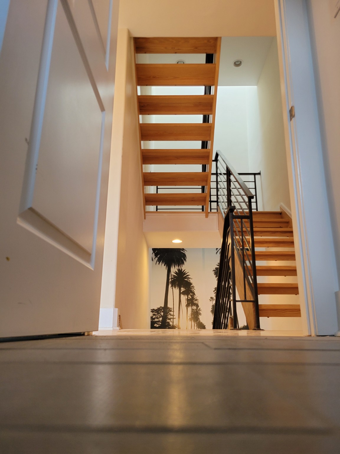 Custom open wood staircase with black metal railing